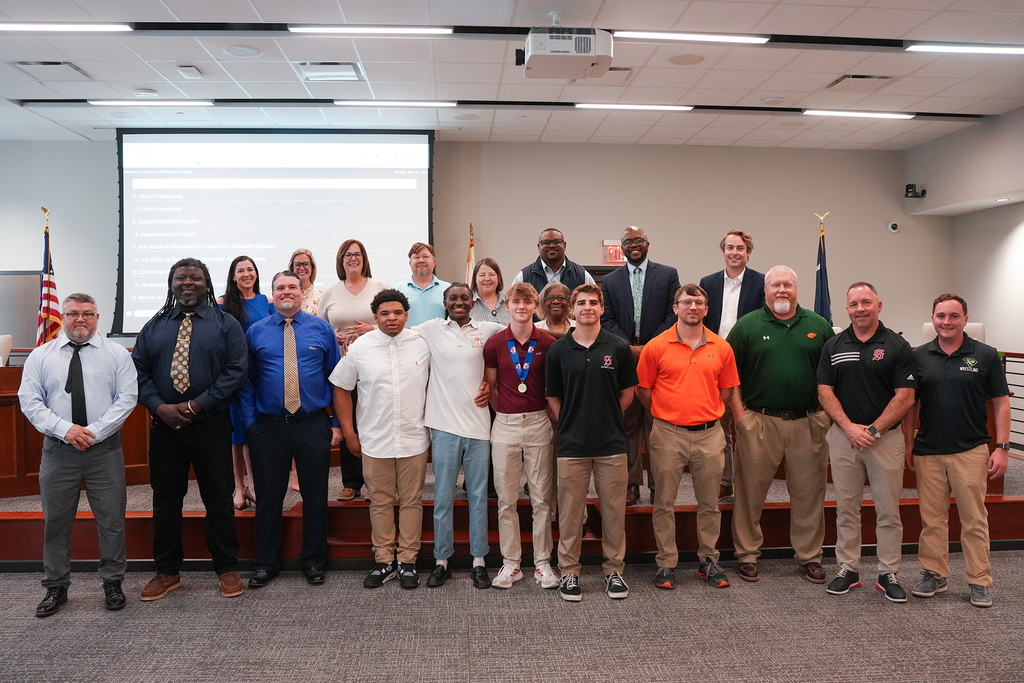 BCSD state champion wrestlers with coaches and BCSD board members