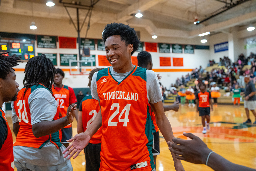 Timberland High student high-fiving other players