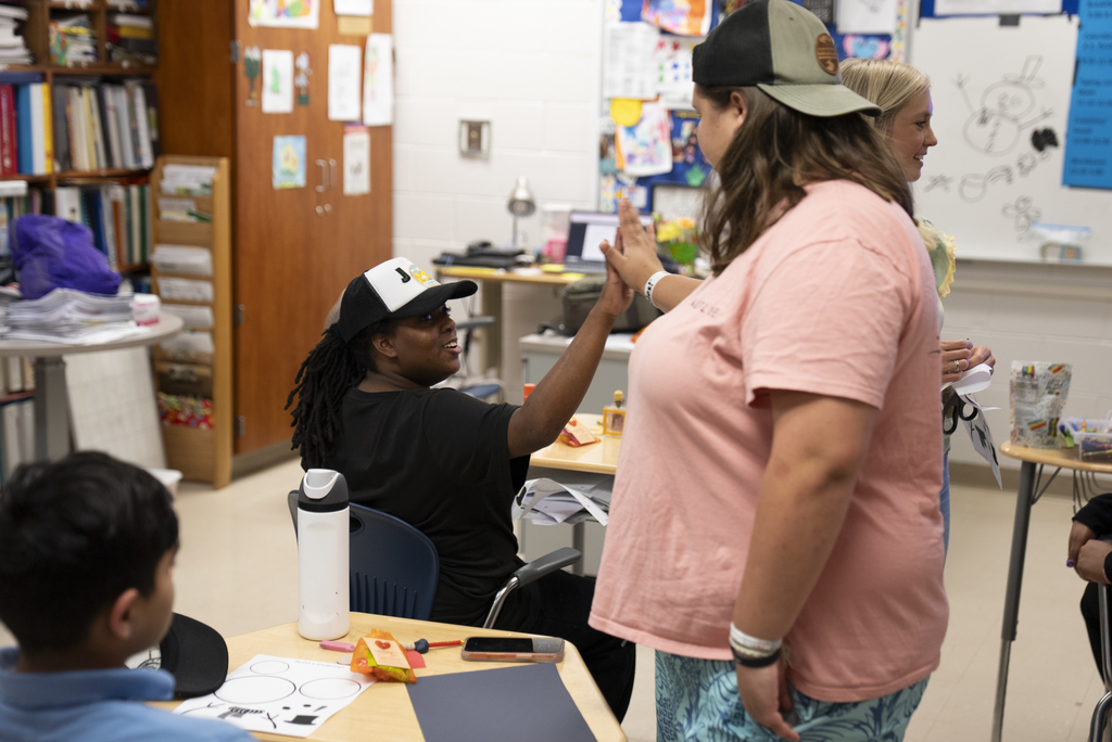 student high -fiving other student