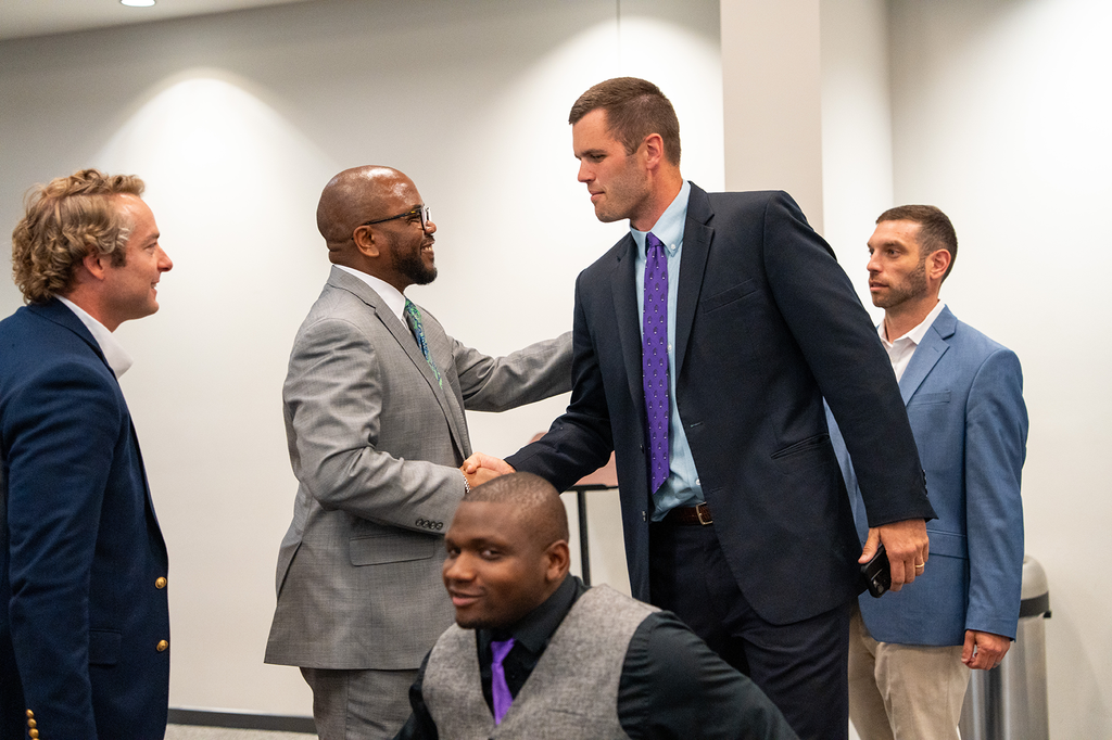Dr. Dixon shaking Coach Garret Campbell's hand