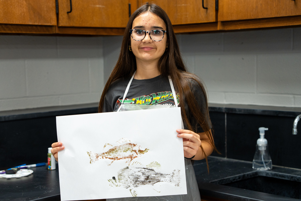 student showing fish prints