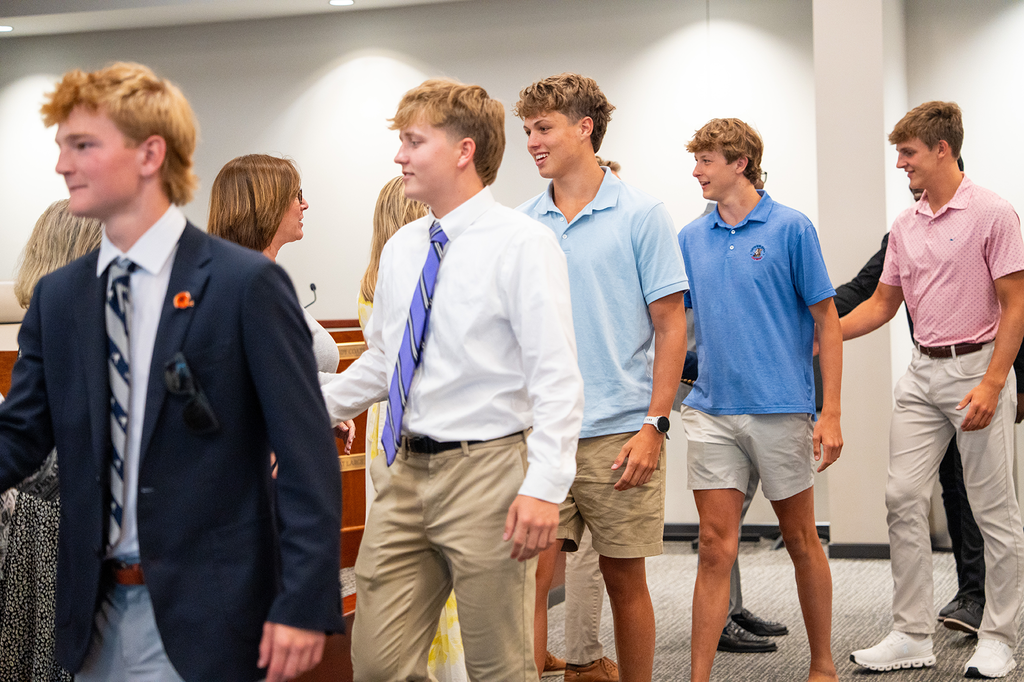 PSH basketball players shaking hands with board members