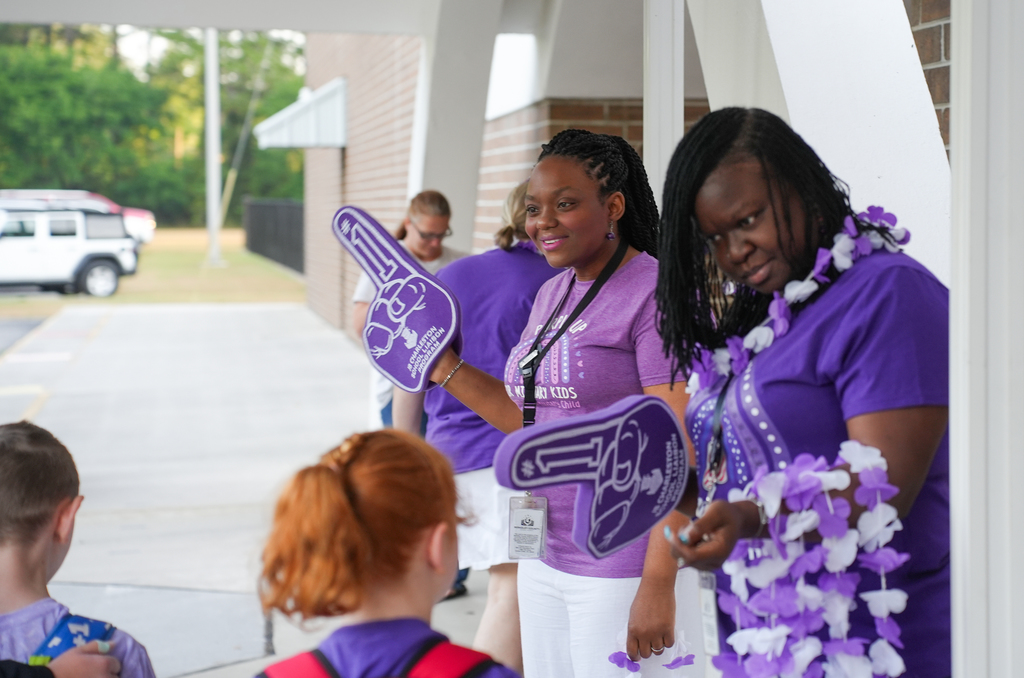 teacher waving foam finger