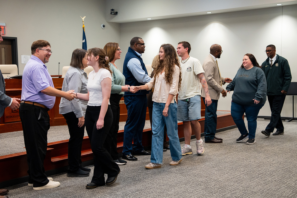 GCH students shaking hands with the board of education