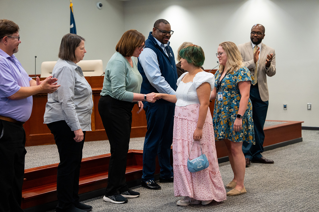 Cane Bay Beta student shakes hands with Board of Education