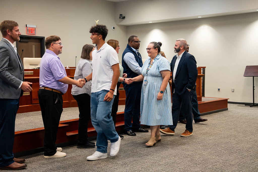 SHS students shake board members hands