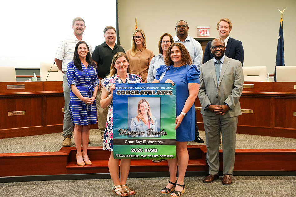 Meagan Brooks with Principal Watson and board members with Teacher of the Year banner