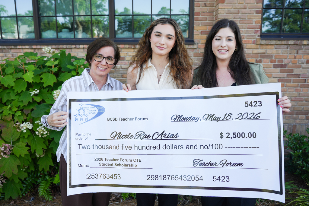 Nicole Arias with family and scholarship check
