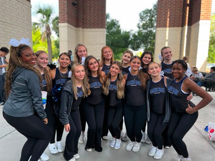 our cheerleaders waiting to welcome our students for high five Friday