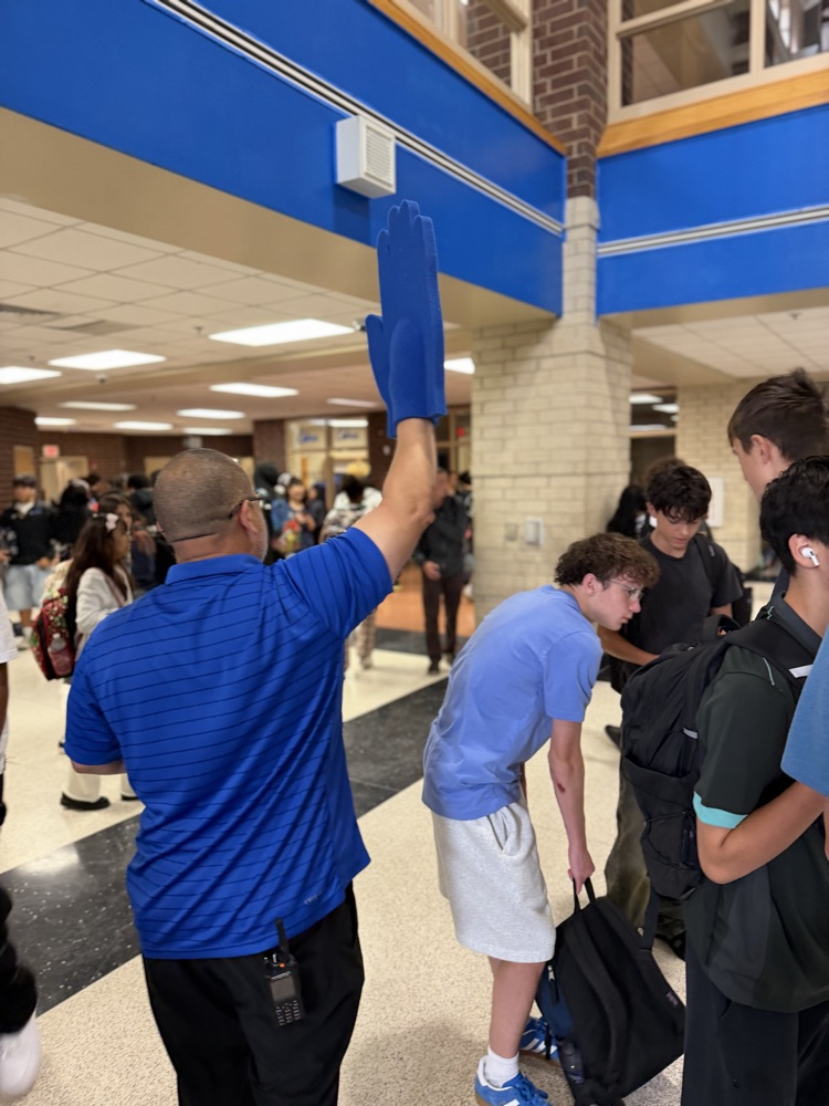Assistant Principal Mr. Rose giving hogh Fives