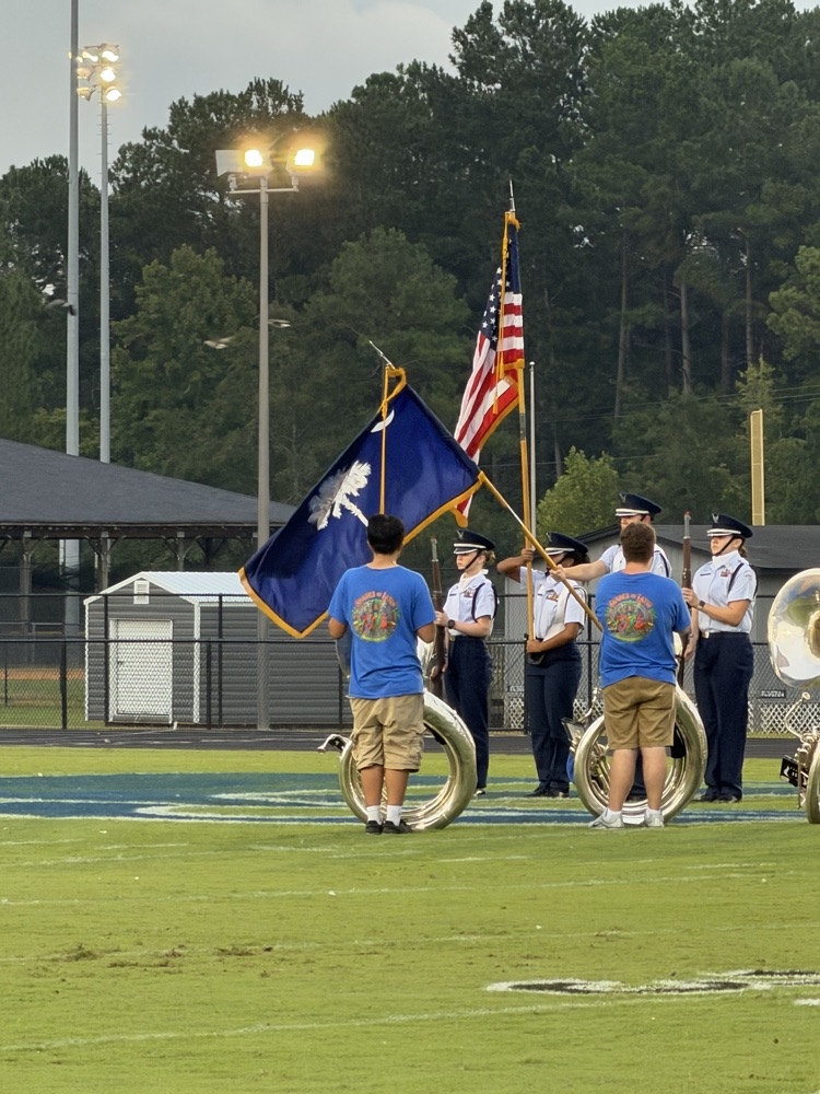 Cane Bay AFJROTC cadets present the American and South Carolina flags on the football field before the game.