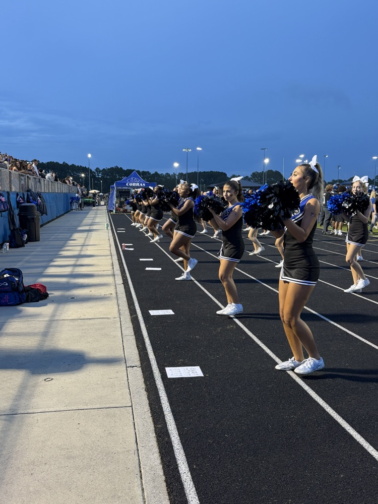 Cane Bay cheerleaders perform along the track during Friday night’s football game.