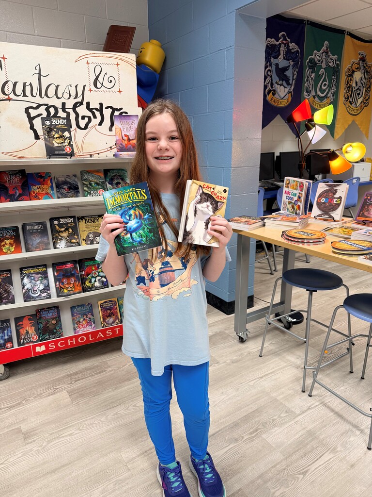 Child holding two bookfair books