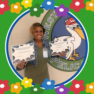 A woman holds two certificates, smiling, with a school logo featuring a pelican in the background.