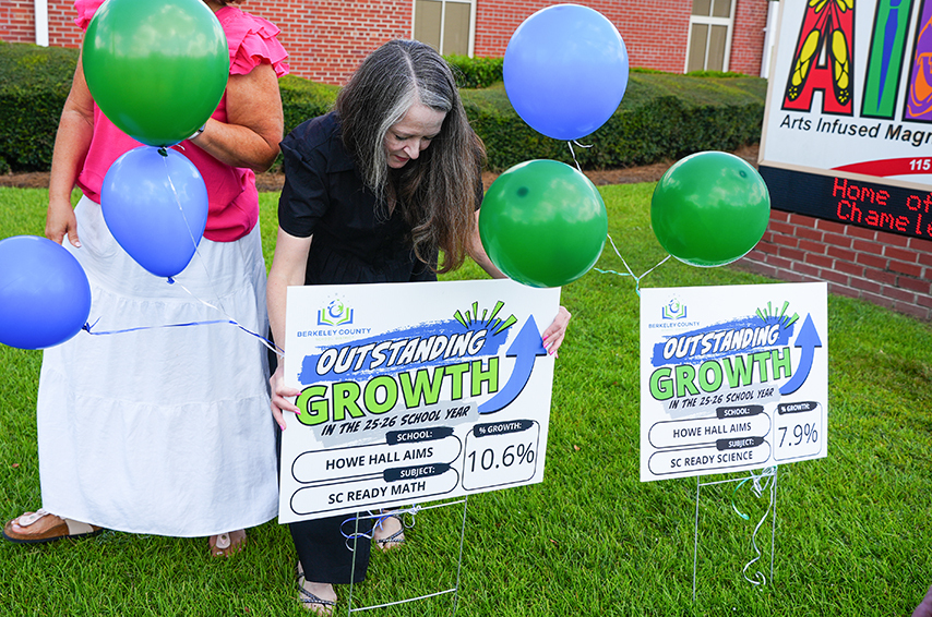 Two women holding signs titled "Outstanding Growth" with percentages 10.6% and 7.9%. They stand on a lawn with balloons.