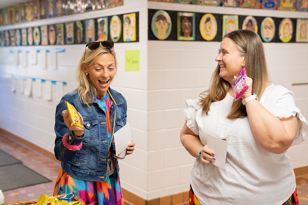 two teachers smiling after getting snacks