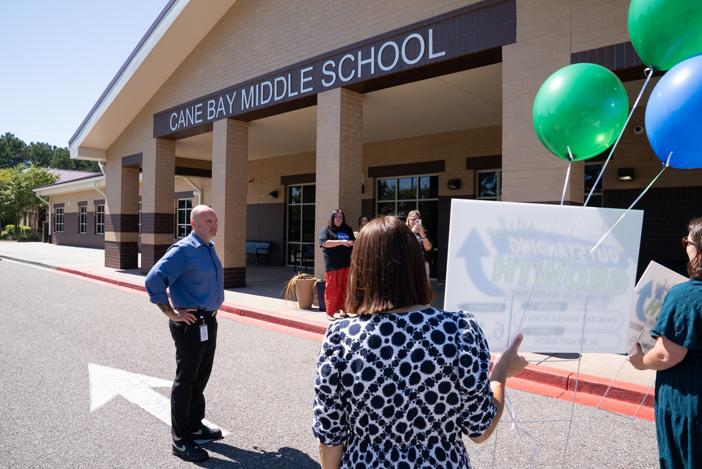 group of people standing outside Cane Bay Middle