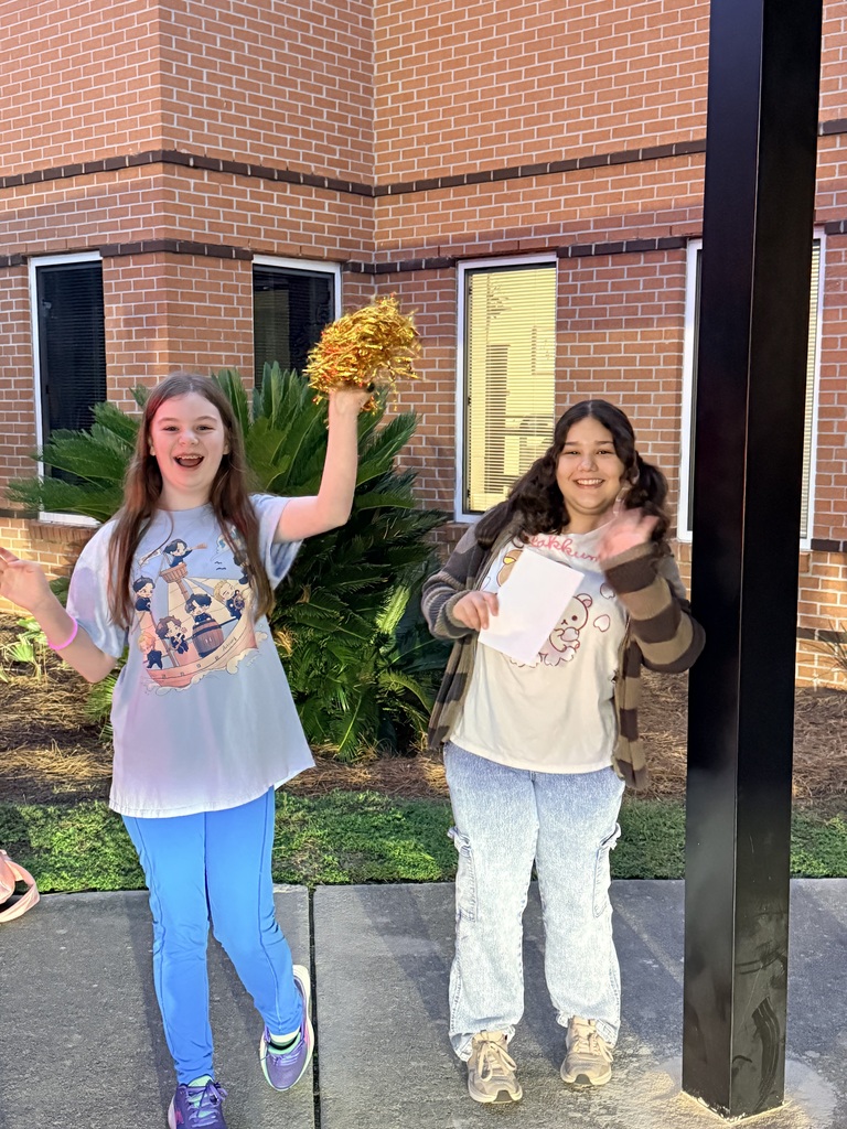 two students great everyone with smiles and waves
