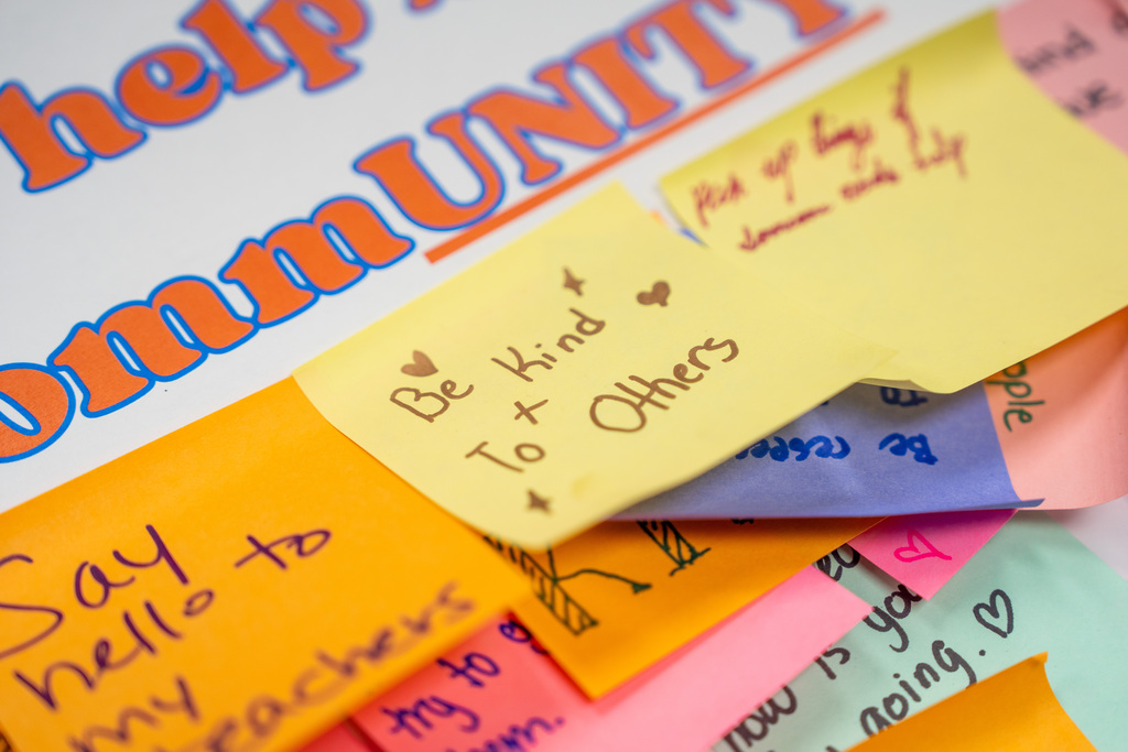 Multiple colorful sticky notes on a white background with messages such as "Be kind to others" and "Say hello to my teachers."