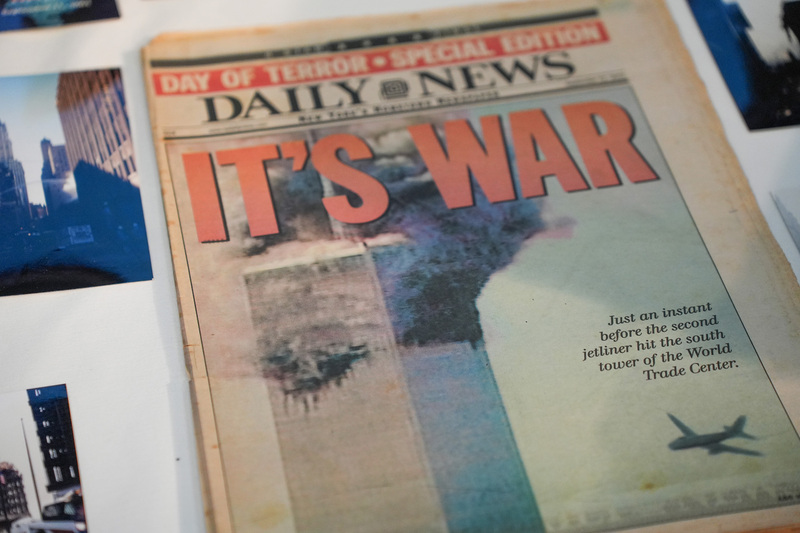 front page of old daily news tabloid reading "it's war" with jetliner about to crash into second tower on 9/11