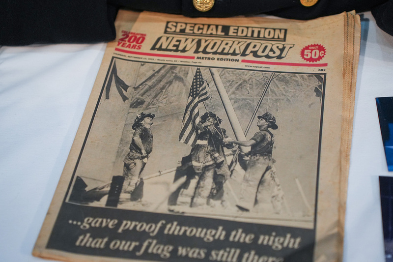 tabloid with famous photo of firefighters erected USA flag at ground zero