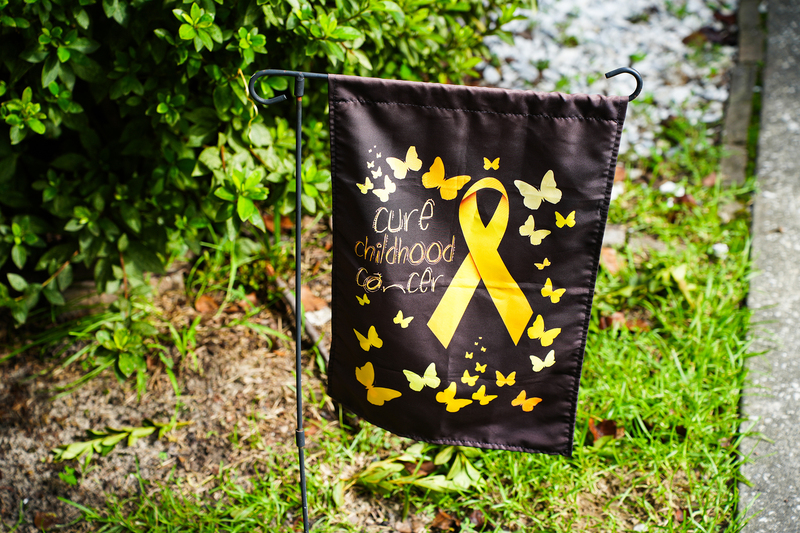 yard sign that reads "cure childhood cancer"