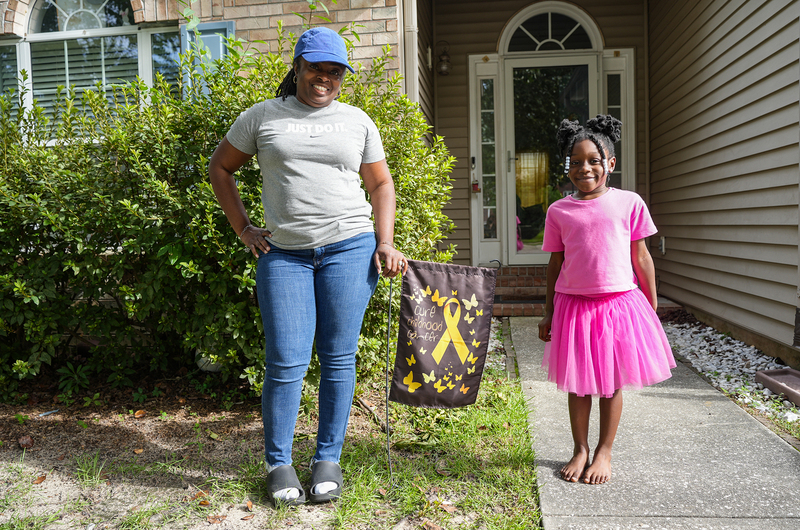 carletta and aviana with yard sign