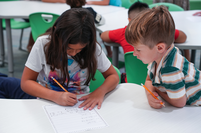 third and first grader working together