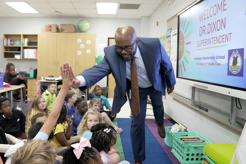dr dixon high fiving students