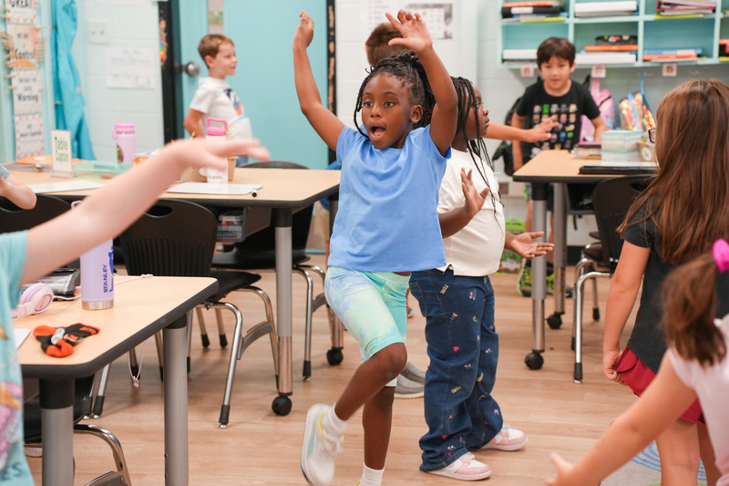 students dancing around classroom