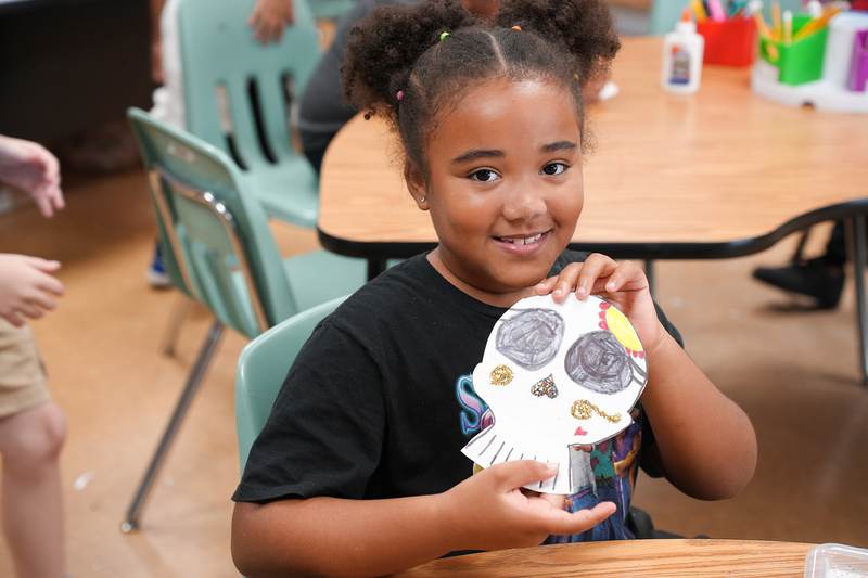 girl holding up project