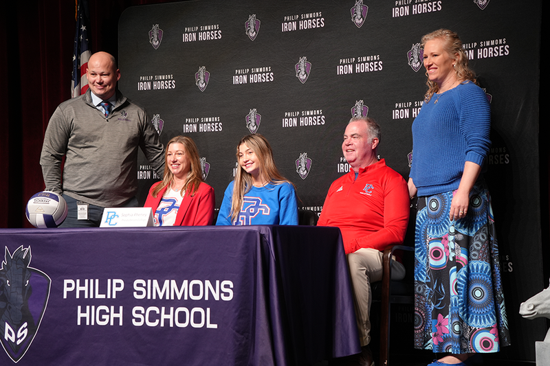Sophia Pheney with family and coaches on  Early Signing Day