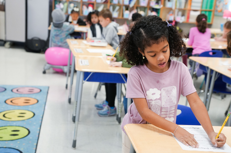 child writing at desk