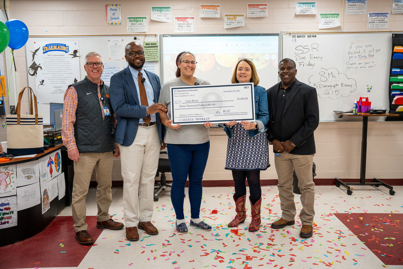 BAS teacher with check