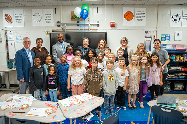 SRI teacher with check and class