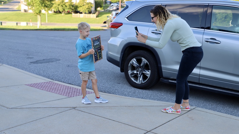 image of mom taking a picture of her son