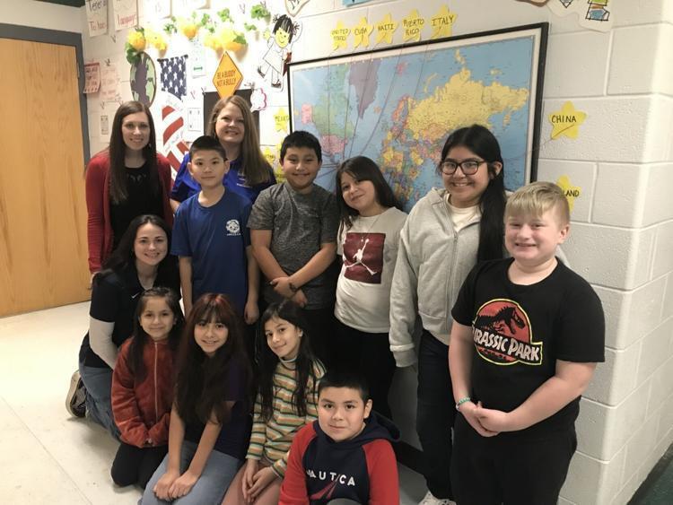 image of students posing for picture with staff at eagle school intermediate