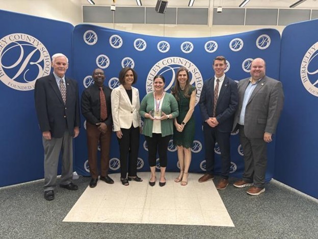 From the left, Board of Education members Patrick Murphy, Damon Wright, and Jackee Long, Teacher and Principal of the Year Rachel Nauman and Alicia Riggleman, board member Michael Martin and Superintendent Ryan Saxe