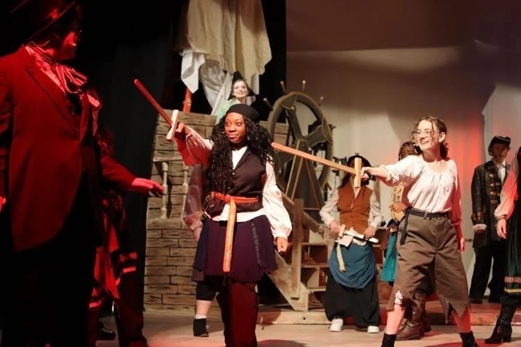 Students performing as pirates on stage