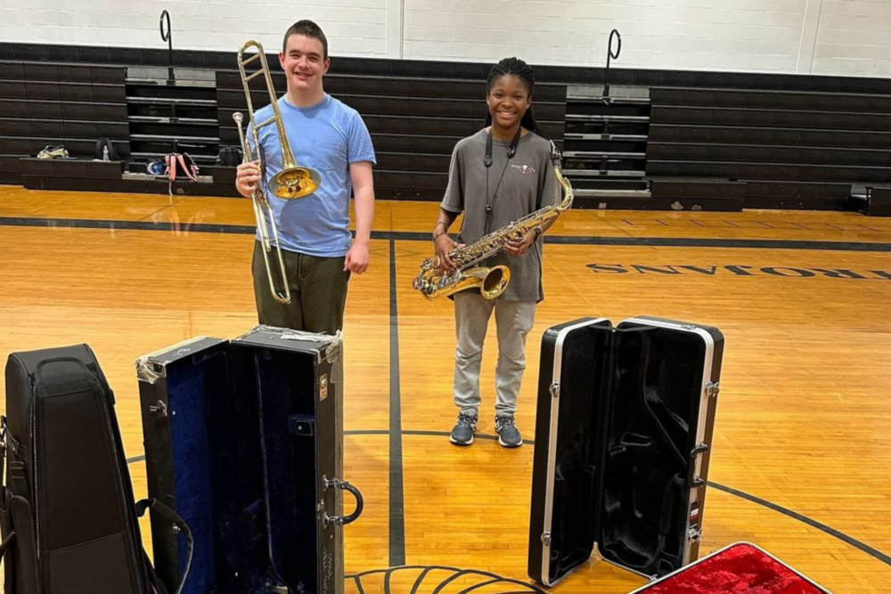students with musical instrument cases