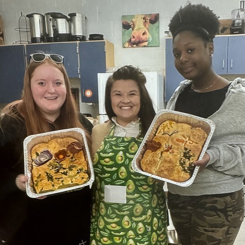 a picture of Ms. Long with two of her students and their baked bread