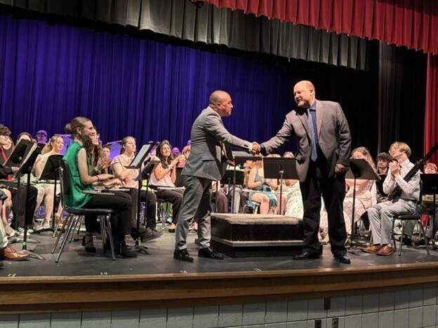 Michael Knepper receiving his award from Mark Albright during the Musselman High School Band's Spring Concert