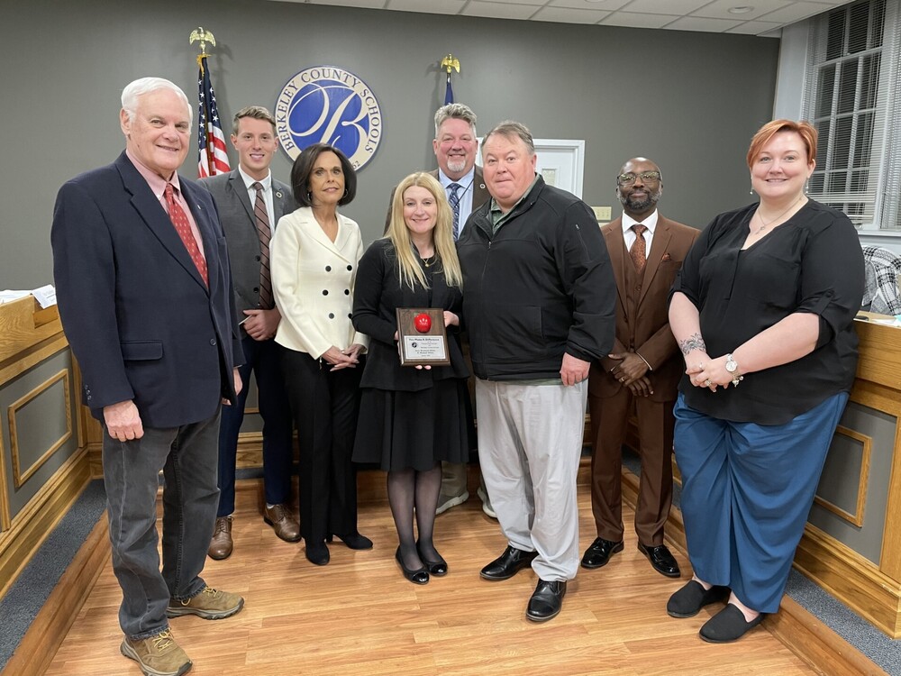 image of sara rockwell-white & michael white receiving volunteer of the month award from board of education