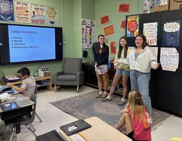 Anna MacKinnon, Claire Stafford and Hailey Kackley teaching financial literacy at Berkeley Heights Elementary School