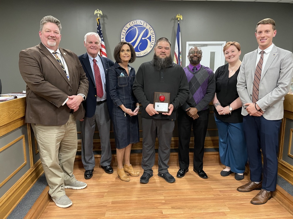 image of volunteer of the month karl collo standing with board members