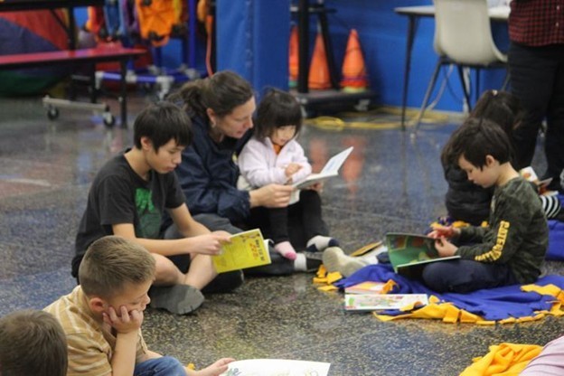 Kids sit and read their new books