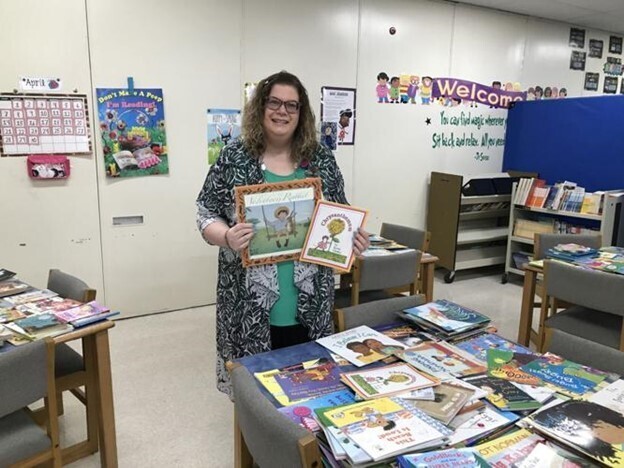 Allison Bixler holds books for book swap
