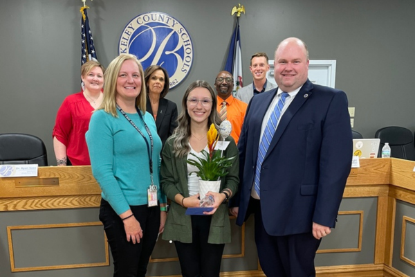 Maggie James with Amy Haderer, members of the board, and Superintendent Saxe