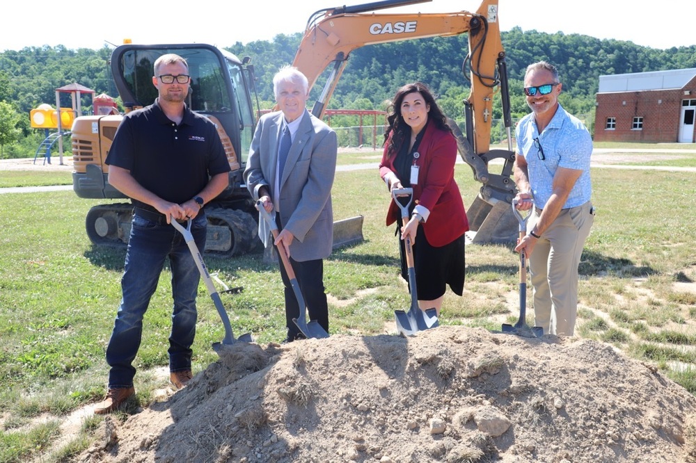 image of people shoveling from a dirt mound at a groundbreaking ceremony
