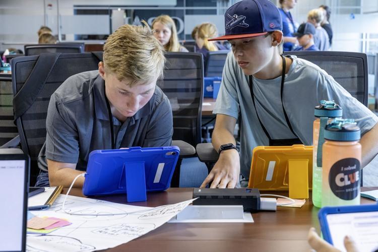 Mason Janney and other student working on iPads
